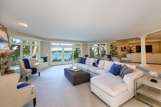 carpeted living room featuring french doors and decorative columns