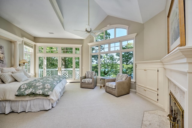 carpeted bedroom featuring lofted ceiling, multiple windows, access to exterior, and ceiling fan