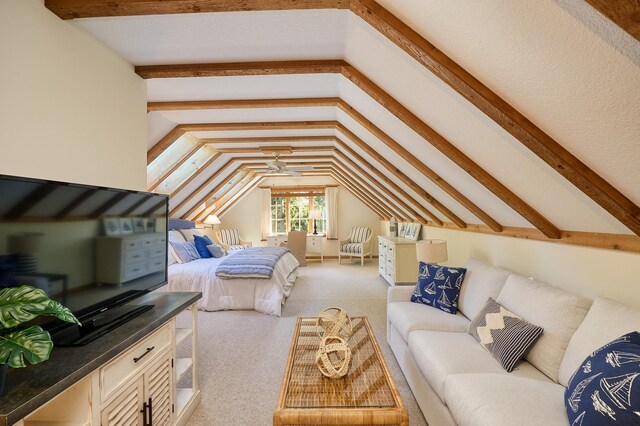 bedroom with vaulted ceiling with beams and light colored carpet