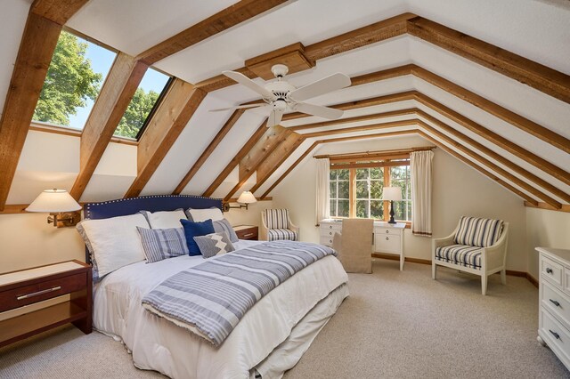 bedroom featuring ceiling fan, light colored carpet, and lofted ceiling with skylight