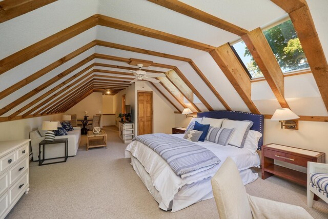 carpeted bedroom with vaulted ceiling and ceiling fan