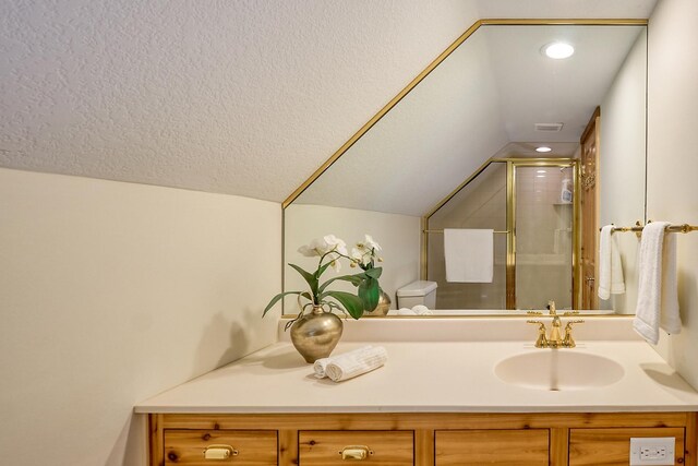 bathroom featuring lofted ceiling, a shower with door, toilet, and vanity