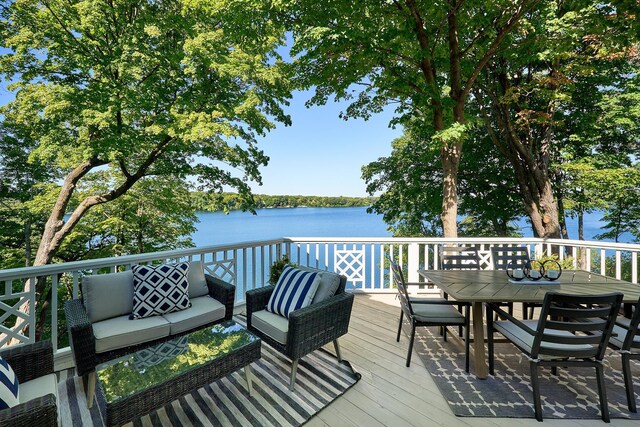 wooden terrace featuring outdoor lounge area and a water view