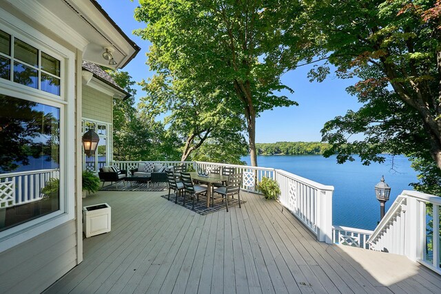 wooden deck featuring a water view