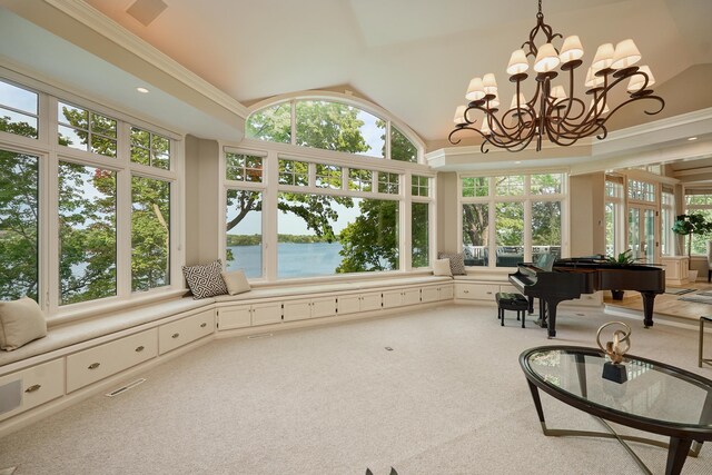 sunroom / solarium with lofted ceiling, a water view, and an inviting chandelier