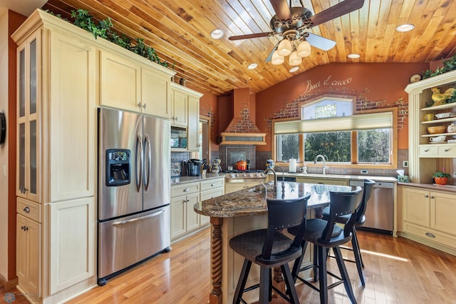 kitchen featuring wooden ceiling, vaulted ceiling, appliances with stainless steel finishes, light wood-type flooring, and custom exhaust hood