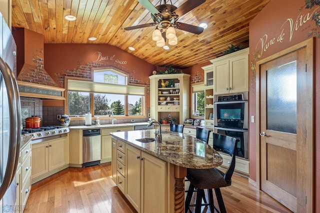 kitchen featuring a healthy amount of sunlight, stainless steel appliances, open shelves, and a sink