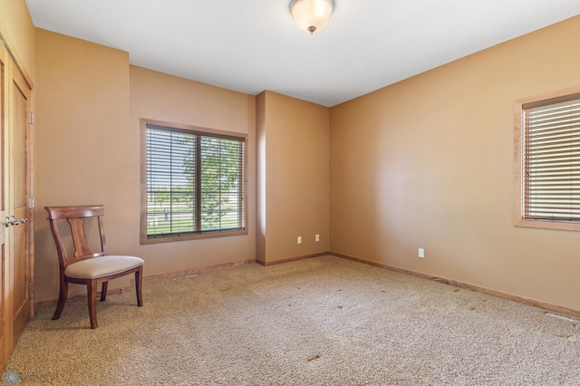 sitting room featuring carpet flooring and baseboards