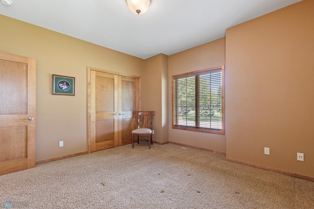unfurnished bedroom with carpet floors, baseboards, and a closet