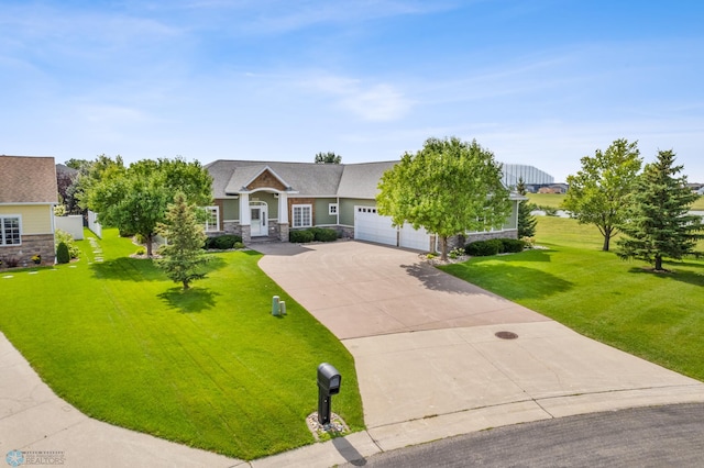 view of front facade with a garage, stone siding, driveway, and a front yard