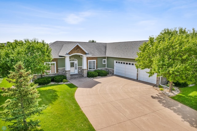 view of front of property with a garage, stone siding, concrete driveway, and a front yard