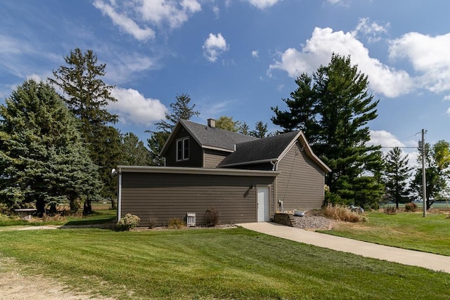 view of property exterior with a yard and a garage