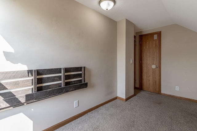 interior space featuring lofted ceiling and carpet floors