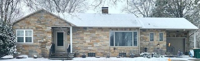 view of front facade with stone siding and a chimney