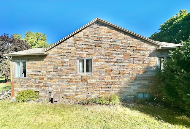 view of side of home featuring stone siding