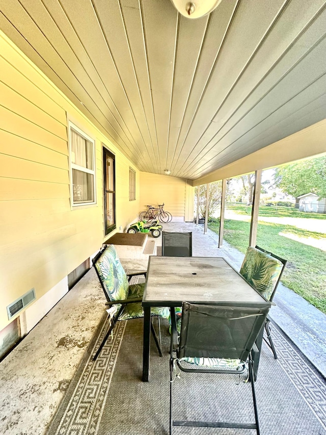 view of patio with outdoor dining area and visible vents