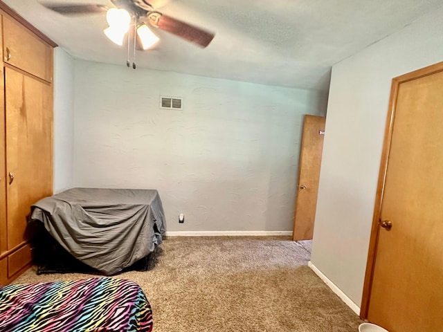 bedroom featuring carpet floors, visible vents, ceiling fan, and baseboards