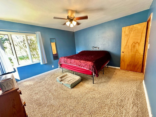 bedroom with carpet floors, a ceiling fan, and baseboards