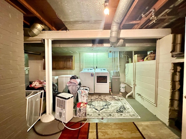 unfinished basement featuring washing machine and dryer