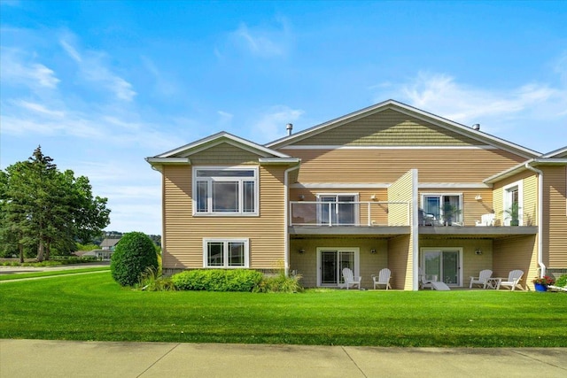 exterior space with a balcony, a yard, and a patio