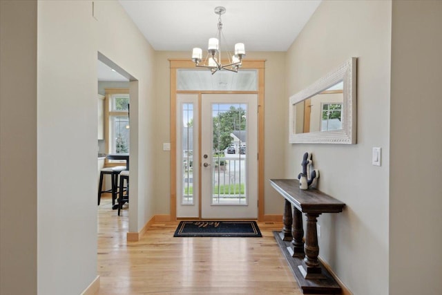 entrance foyer with a chandelier and light hardwood / wood-style floors