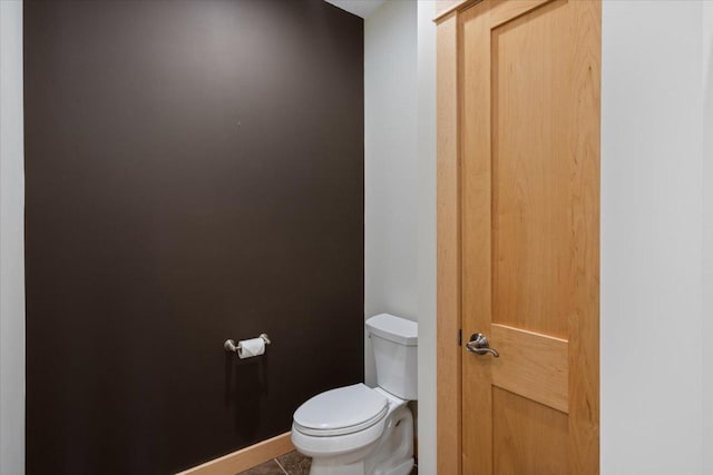 bathroom with tile patterned flooring and toilet