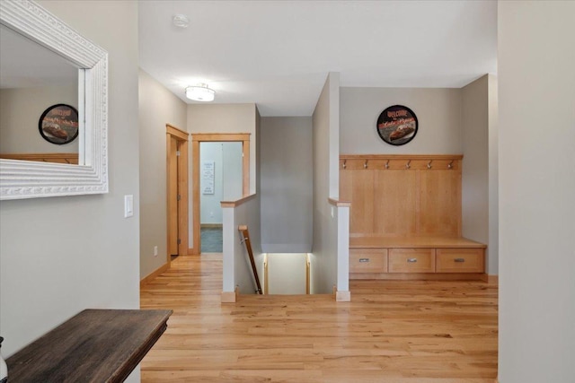 hallway with light hardwood / wood-style floors