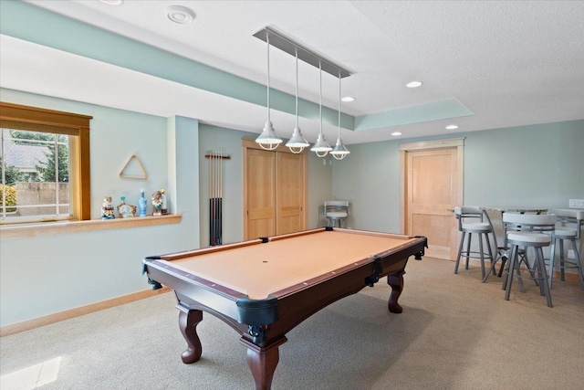 game room with light colored carpet, a tray ceiling, and pool table