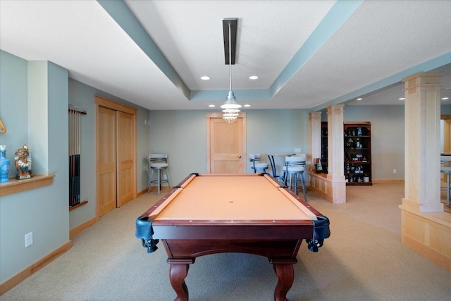 rec room with light colored carpet, a raised ceiling, billiards, and ornate columns