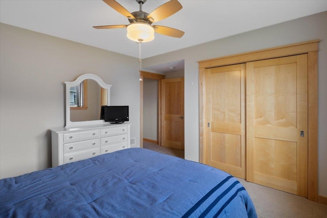 carpeted bedroom with a closet and ceiling fan