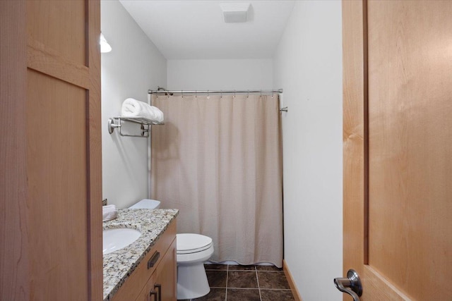 bathroom featuring vanity, toilet, a shower with shower curtain, and tile patterned floors