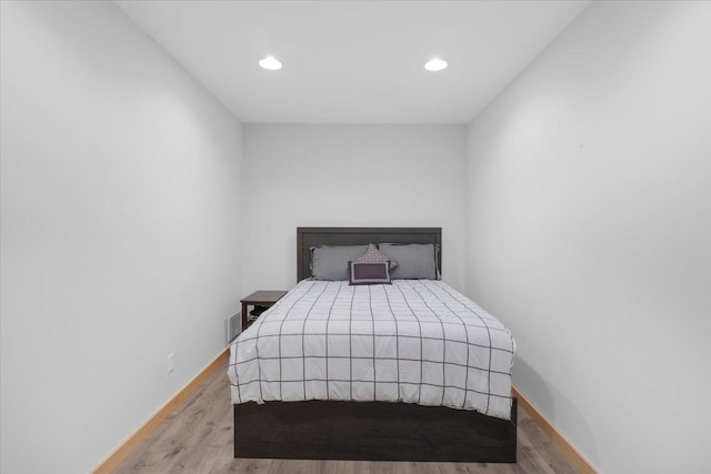 bedroom with hardwood / wood-style flooring