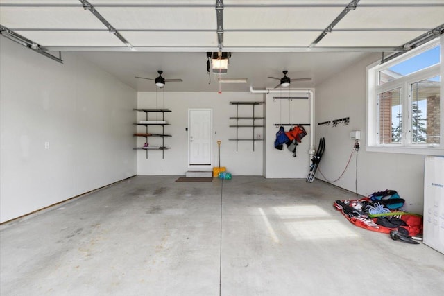 garage with a garage door opener and ceiling fan