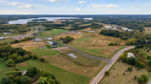 drone / aerial view with a rural view and a water view