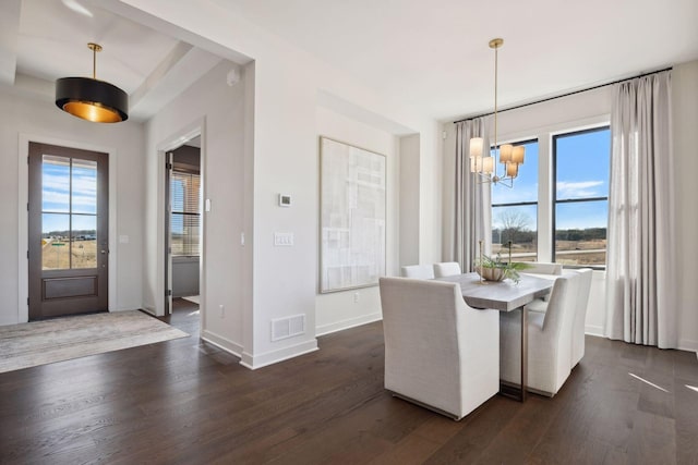 unfurnished dining area with visible vents, dark wood finished floors, and a wealth of natural light