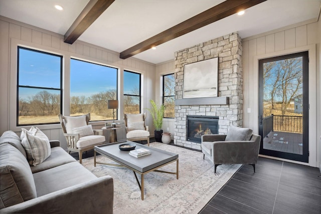 living area featuring a fireplace and beamed ceiling