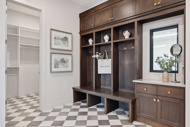 mudroom with light floors and baseboards