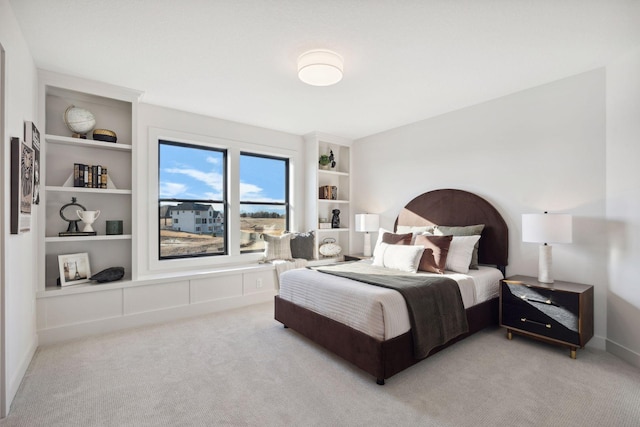 bedroom featuring baseboards and light colored carpet