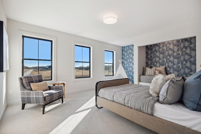 bedroom featuring light carpet and baseboards