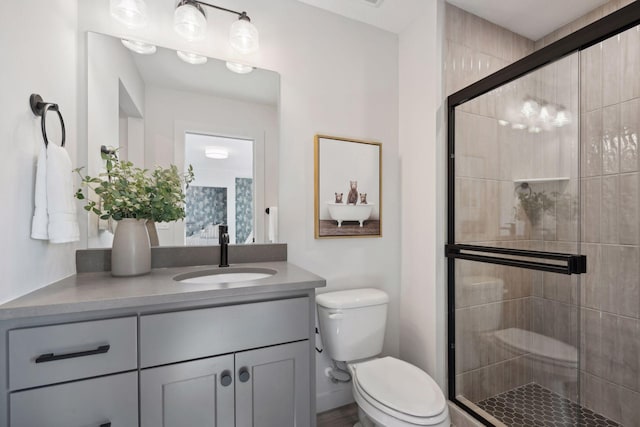 full bath featuring a shower stall, toilet, and vanity