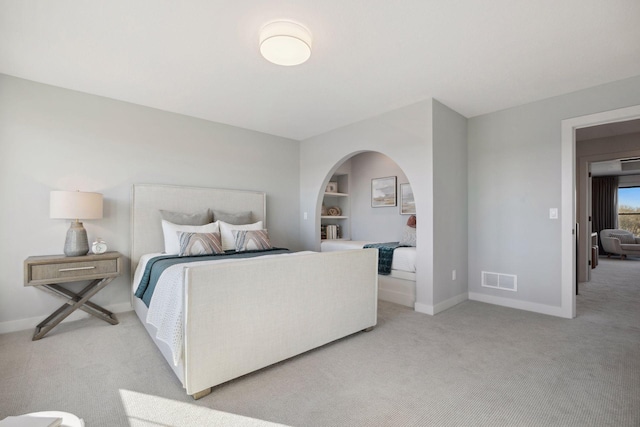 bedroom featuring light carpet, baseboards, and visible vents