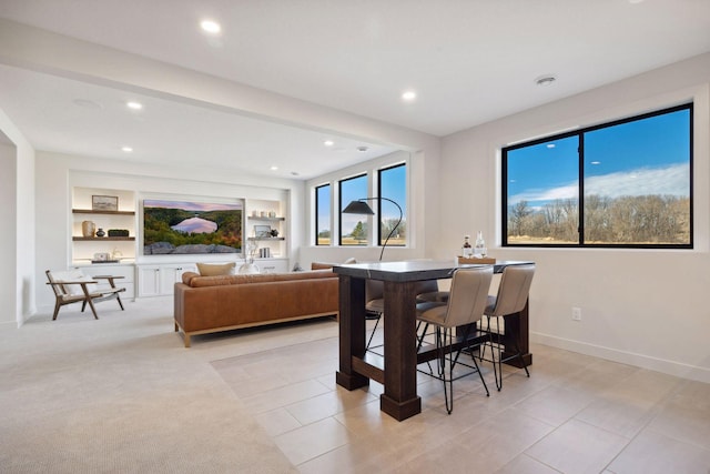 dining space with built in shelves, recessed lighting, and baseboards