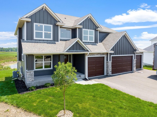 craftsman house with a front yard and a garage