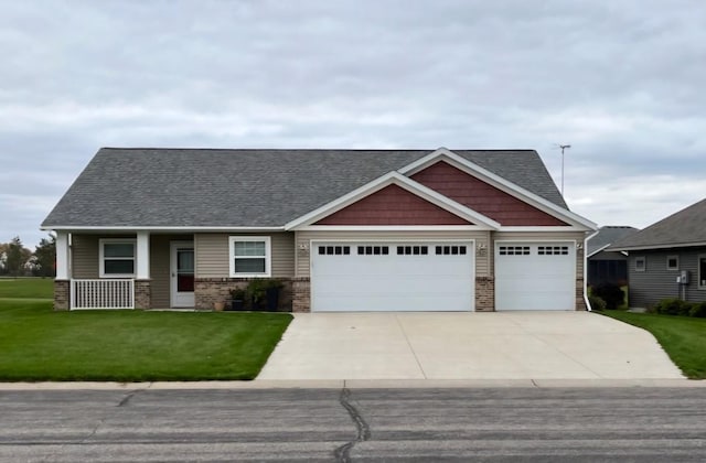 craftsman-style home featuring a garage, covered porch, and a front lawn