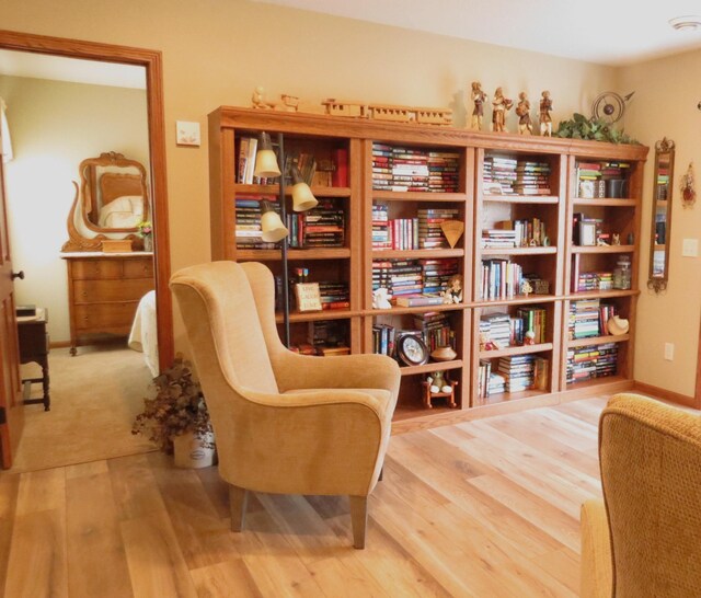 sitting room with wood-type flooring