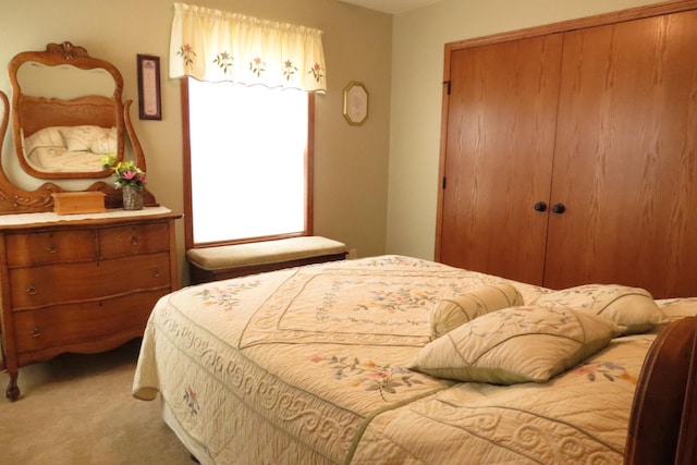 bedroom featuring light carpet and a closet