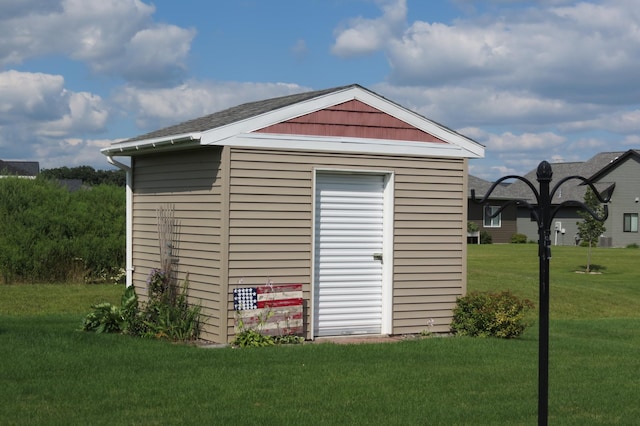 view of outbuilding featuring a yard