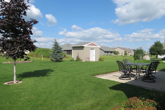 view of yard with a storage unit and a patio area