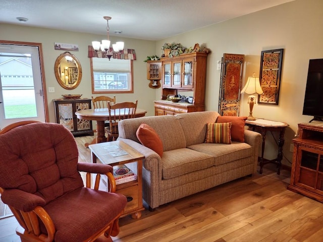 living room with a chandelier and light wood-type flooring