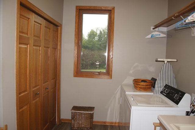 laundry area with washing machine and clothes dryer and dark hardwood / wood-style floors